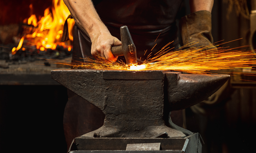 Blacksmith hammering on an anvil